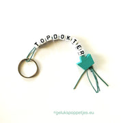 Keyring top doctor with lucky doll crown