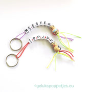 Keyring master with wooden lucky doll