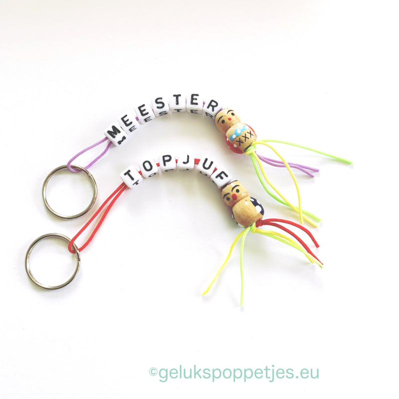 Keyring master with wooden lucky doll