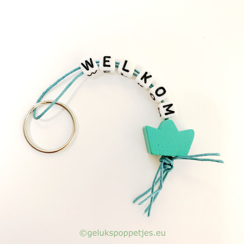 Welcome keychain with lucky charm crown