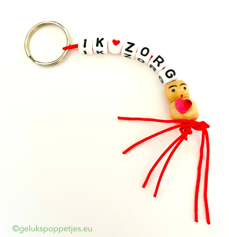 Keychain I ❤️ care with a lucky charm heart on the belly