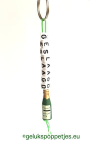 Graduation keyring with lucky charm and wine bottle